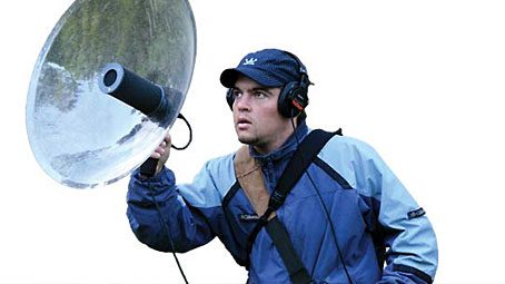 Julián Quillén Vidoz of the Museo de Historia Natural Noel Kempff Mercado uses a parabolic microphone to amplify the call of a distant bird. Photo by Greg Budney