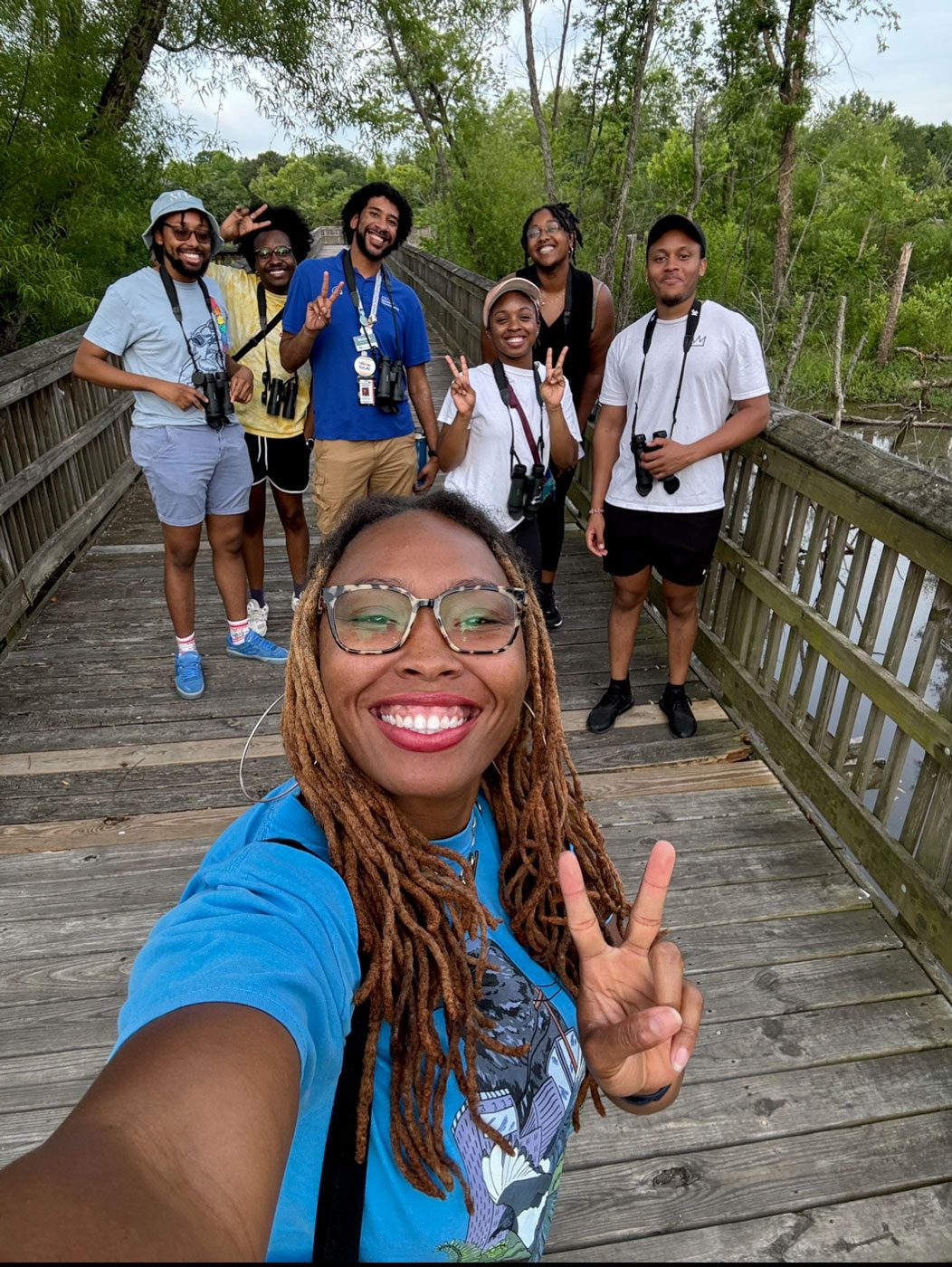 A selfie of a group of smiling black birders.