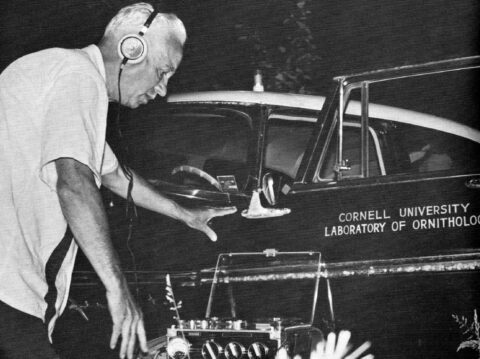 Black and white photo of a man with recording equipment