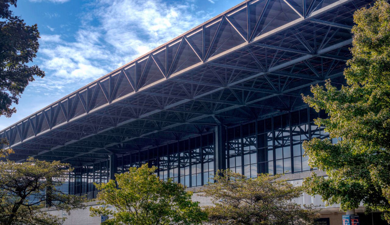 A large building with steel frame and lots of windows.