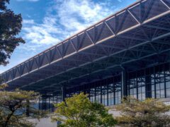 A large building with steel frame and lots of windows.